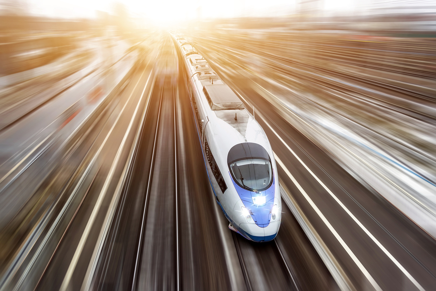 High-speed passenger train travels at high speed. Top view with motion effect, greased background